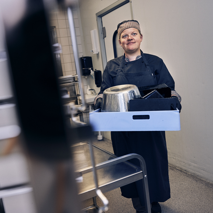 Girl caring pots and utensils to the ware washing